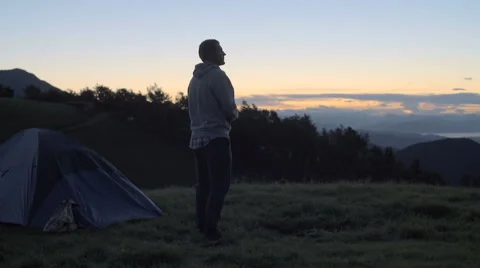 Young man looking around panorama and stretches in nature mountain outdoor Video stock 64543531