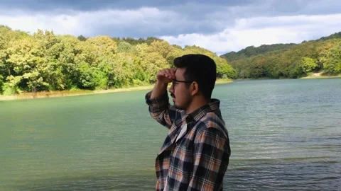 Young man looking away by using his hand Stock Footage 219091773