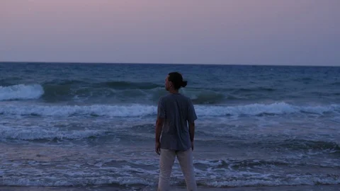 Young man looking on big waves Stock Footage 104822966