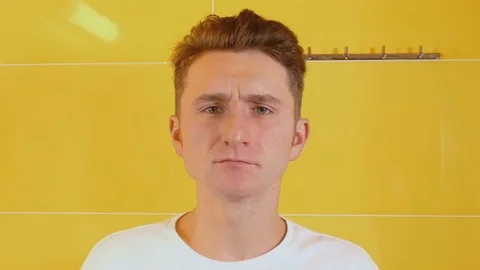 Young man looking at camera and brushing teeth Stock Footage 71779023