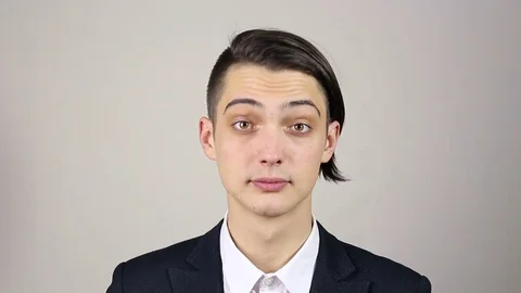 Young man looking at camera and winks Stock-Footage 73667826