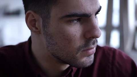 Young man looking at camera and then smiling. Portrait of a happy man Stock Footage 105321122