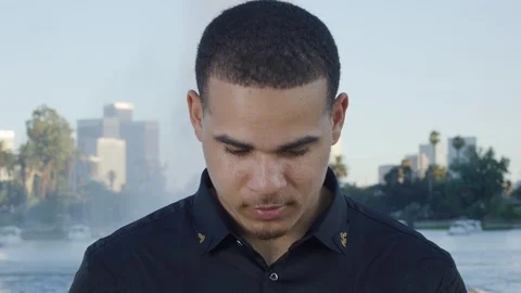 Young man looking up to the camera and smiling in Los Angeles Stock Footage 119335543