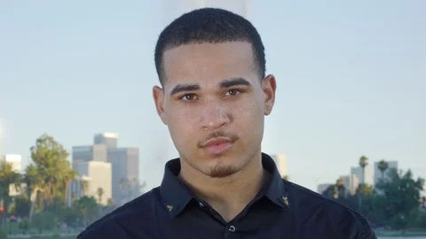 Young man looking at camera and then putting VR glasses on Stock Footage 119336413