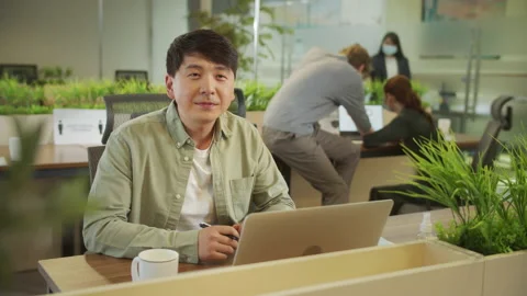 A young man is looking to the camera and smiling Stock Footage 160173366