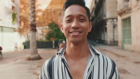 Young man looking at the camera and smiling. Camera moving forwards Stock Footage 227107691