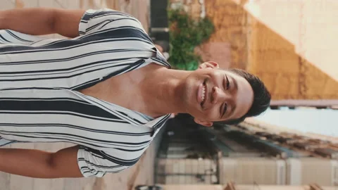 Young man looking at the camera and smiling. Camera moving forwards Stock Footage 227108029