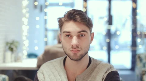 Young man looking at the camera in cafe 스톡 동영상 63047925