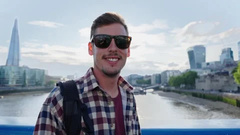 Young man looking at the camera with a cheerful expression Stock Footage 317053918