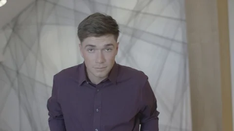 Young man looking at camera engaged in small company projects Video stock 94236133