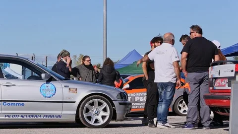 Young man looking at the camera in a funny on a modified cars meeting Stock Footage 119874250