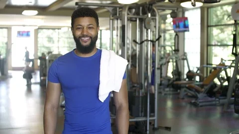 Young man looking at camera while standing in a gym 動画素材 83391278