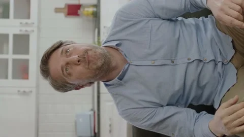 Young man looking at camera while sitting on sofa at home. Stock Footage 196107112