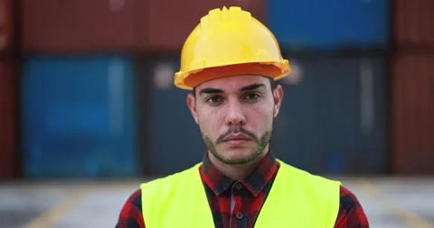 Young man looking on camera working at freight terminal port Stock Footage 179971444