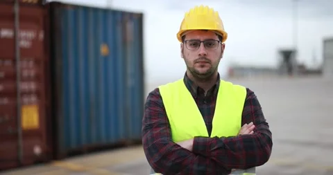Young man looking on camera working at freight terminal port on background Stock Footage 179973498