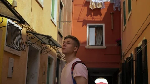 Young man looking into the camers in the old town Stock Footage 112433713