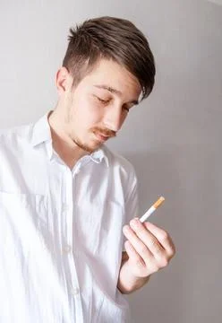 Young Man looking at a Cigarette Foto stock