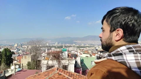 Young Man Looking at City From the Rooftop Stock Footage 150187968