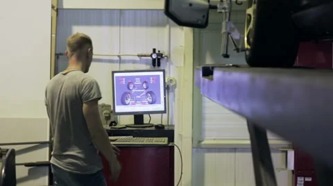 Young man looking at the computer reading condition his car Stock-Footage 67949239