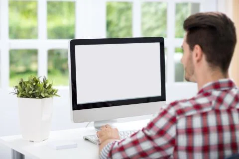 Young man looking at computer screen 스톡 사진