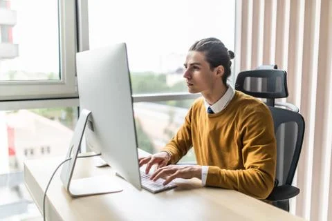 Young man looking at computer screen at home Stock Photos