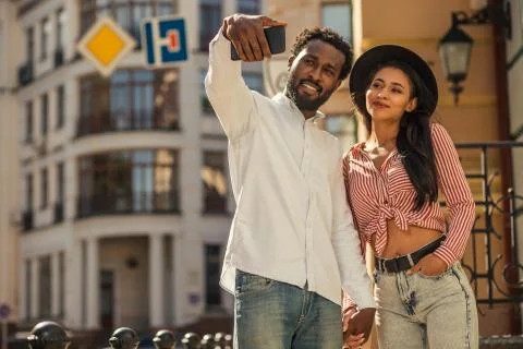 Young man looking confident while taking selfie with girlfriend Stock Photos