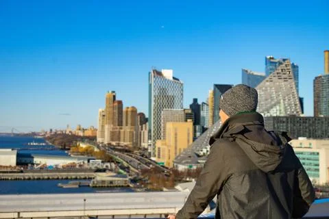 Young man looking from cruise ship to New York cityscape. Concept of happy Stock Photos