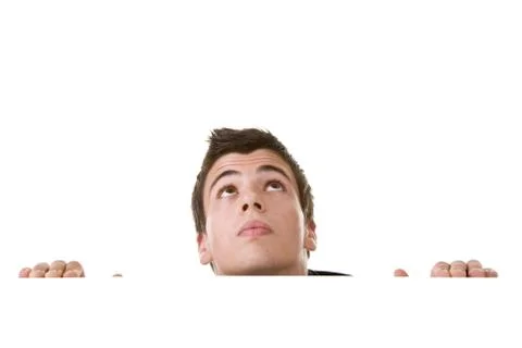 Young man, looking up with curious expression. Stock Photos