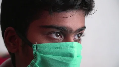 Young man looking desperate with mask on virus bacteria pollution covid close up Video stock 127678482