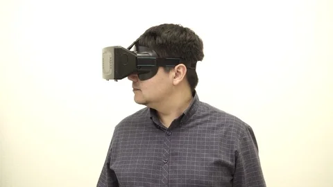 Young man looking in different sides in the virtual glasses Stock Footage 73998268