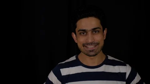 Young man looking directly at camera pov and raises his hand with a thumbs up si Stock Footage 104900214