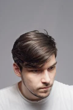 Young man looking down, feeling sad. Stock Photos