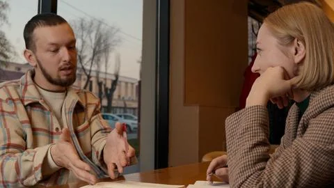 Young man looking focused and serious during a discussion in a cafe Stock Photos