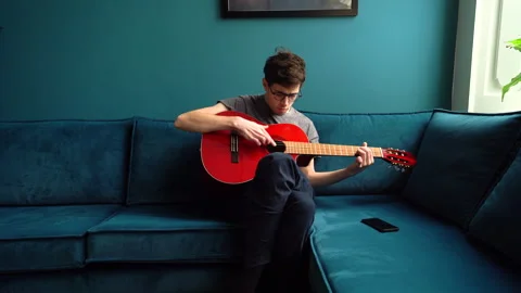 Young Man looking up Guitar Chords but Fails Stock Footage 274189470