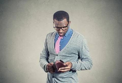 Young man looking into his empty wallet has no money Stock Photos