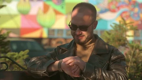 Young man looking at his watch outdoor in the city street Video stock 161084085