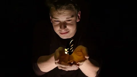 Young man looking at a holographic rotating Euro sign in his hands. Stock Footage 110315588