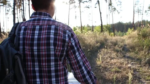  Young man looking a map in a forest at sunset Stock-Footage 69060470