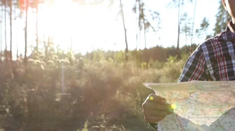  Young man looking a map in a forest at sunset Stock-Footage 69060475