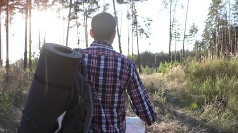  Young man looking a map in a forest at sunset Stock-Footage 69060482