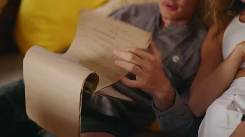 Young man looking at menu, flip pages. Couple in love choosing dessert in Stock Footage 269491553