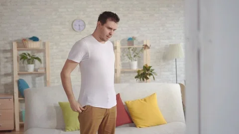 Young man looking in the mirror finds himself at the waist folds. Stock-Footage 106538667