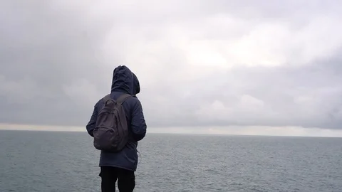 Young man looking at ocean view Video stock 102782289