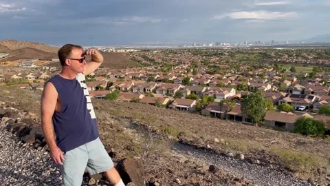 Young man looking out on Las Vegas valley from hill in Henderson, Nevada Stock Footage 252146493