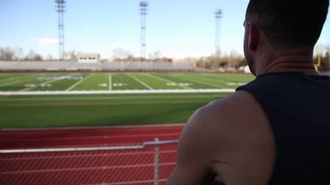 Young Man looking out over stadium Stock Footage 73405863