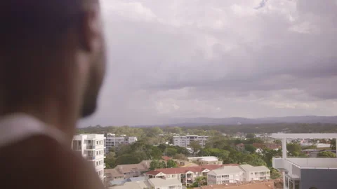 Young man looking out over balcony at scenic view. Close up on 4k RED camera. Stock Footage 199459967