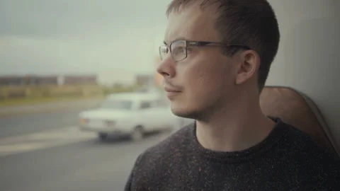 Young man looking out the window during bus ride Stock Footage 97958162