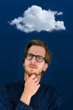 Young man looking pensive to a cloud above him Foto stock