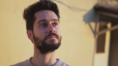Young Man looking up, on Rooftop of a building, on yellow background , Slow M Stock Footage 106671630