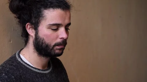 Young man looking sad reflecting on life Stock Footage 320255880